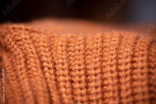 Fototapeta Orange wool scarf background texture. Macro photo with selective focus.
