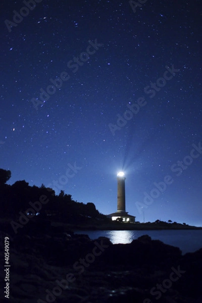 Fototapeta Lighthouse and stars at night