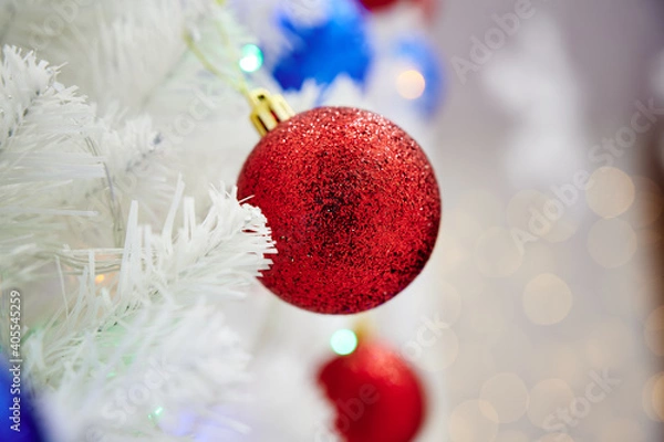 Obraz Red Christmas ball toy on a white Christmas tree