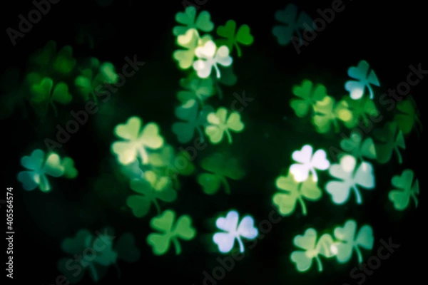 Obraz background texture with glowing blurred green clover leaves