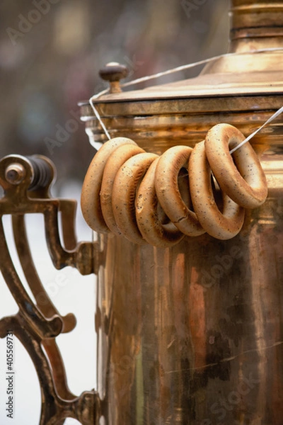 Fototapeta Sushki on a string hanging on old copper Russian samovar
