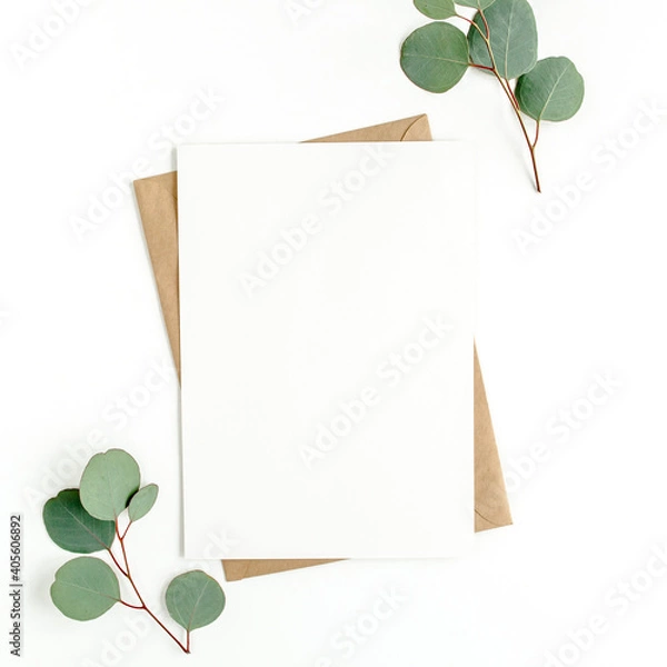 Fototapeta Mockup invitation, blank greeting card and green leaves eucalyptus. Flat lay, top view.