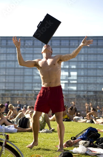 Fototapeta man balancing backgammon/suitecase on head in the sun 