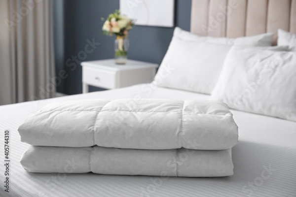 Fototapeta Soft folded blanket on bed at home