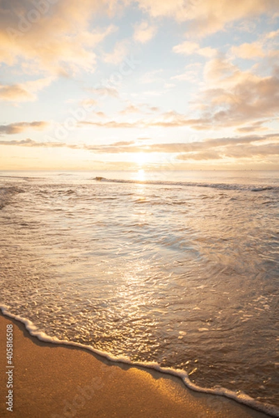 Fototapeta Wonderful golden sunset on the beach and calm sea.