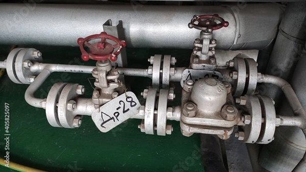 Obraz Pipelines and fittings of thermal equipment. High pressure steam lines. Industrial equipment. Thermal power plant.
