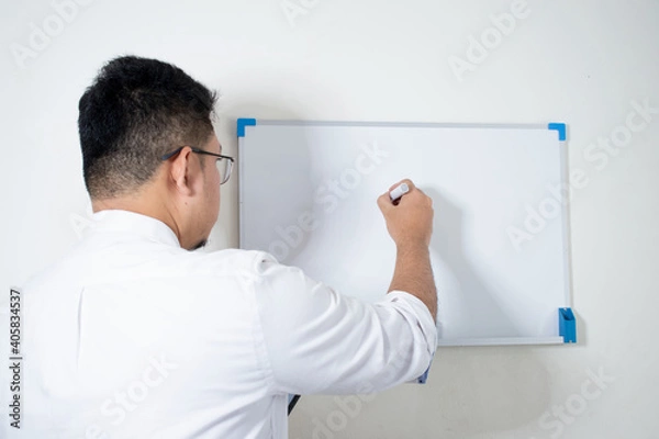 Obraz Businessman writing in a whiteboard