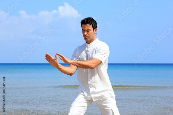 Fototapeta man on the beach meditating
