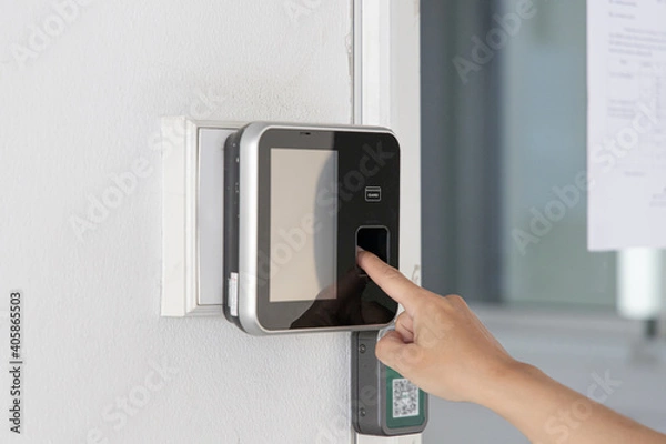 Fototapeta Finger print scan, Male employees press sensors to record company attendance time and after work, Time Recorder Attendance - Out work, Encryption for identity verification or electronic signing