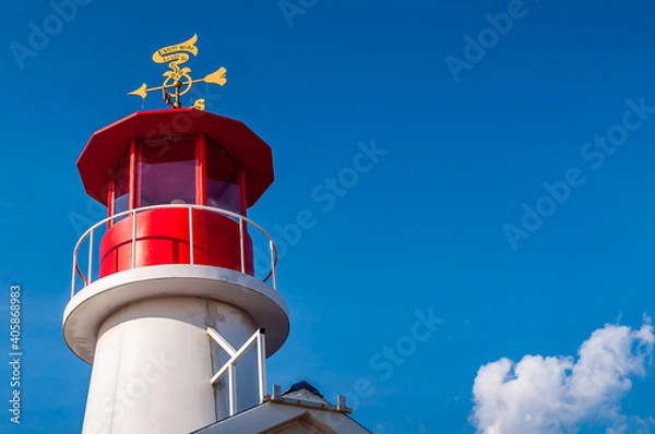 Fototapeta Coney Island, Brooklyn, New York, USA - August 21, 2020.
Close up view of the beacon atop bar on Coney Island promenade. Blue sky with cloud in the background. 
