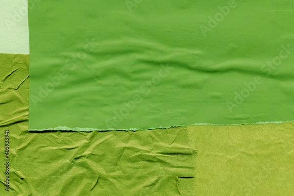 Fototapeta Green torn paper collage close-up. Texture made from various paper and cardboard parts. Damaged old paper background. Vintage blank wallpaper. Material design backdrop.