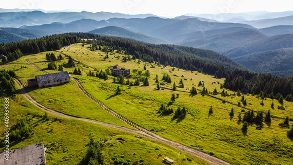 Fototapeta Drone view over authentic wooden huts in mountains.
