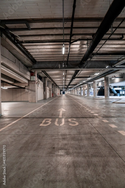 Fototapeta Interior of an underground bus parking with no vehicles.