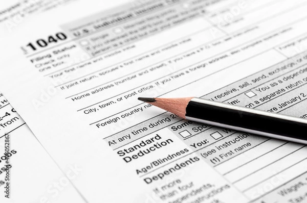 Obraz Pencil on tax forms 1040. Close up. Filing tax report.