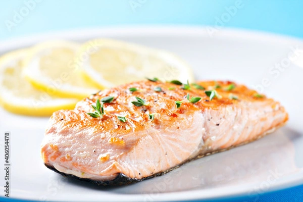 Fototapeta Fillet of salmon with asparagus on a plate.