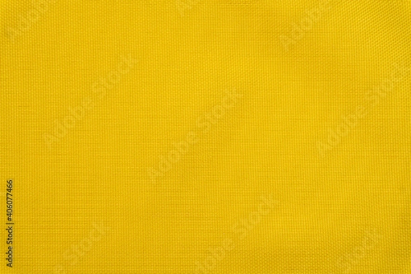 Fototapeta Bright yellow background made of textile material. Fabric with natural texture. Fabric isolated background.