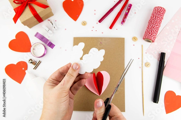 Fototapeta Valentine's Day. Instructions for making cards for Valentine's Day. Step 4 Cut out two clouds from white paper.