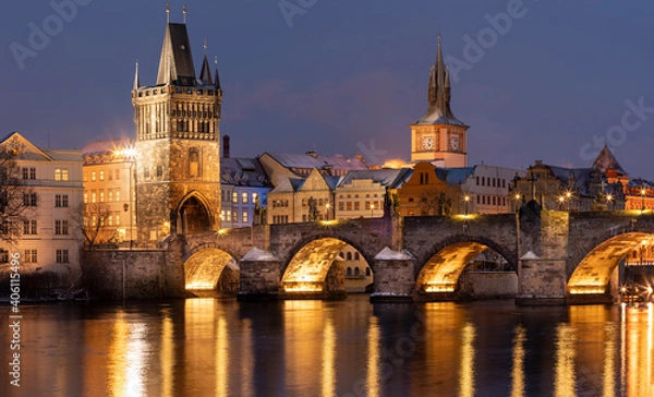 Fototapeta .Charles Bridge on the Vltava River and statues on the bridge and light from the street lights and a fallen dream in winter in the early evening in the center of Prague
