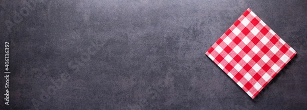 Fototapeta Folded checked or checkered tablecloth at stone surface of table. Panorama of cloth napkin texture background