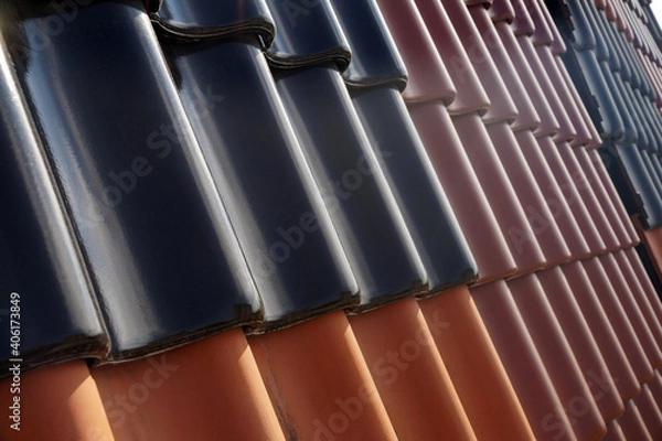 Fototapeta Roof covered with tiles in different colors. Roofing.