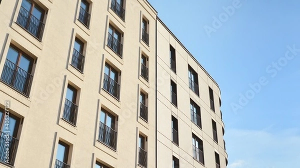 Fototapeta Fragment of modern luxury residential apartment,  home house building concept. Modern apartment building on a sunny day with a blue sky.