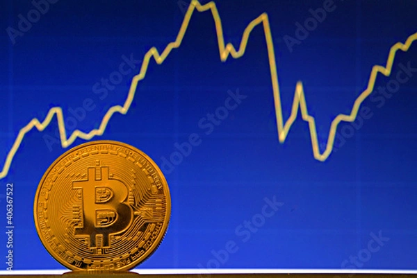 Fototapeta Bitcoin coin on the background of the stock chart. Virtual cryptocurrency concept.