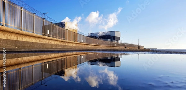 Obraz Heysham nuclear power station reflected in a puddle.