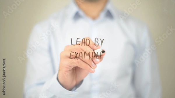 Fototapeta Lead by Example , Man writing on transparent screen