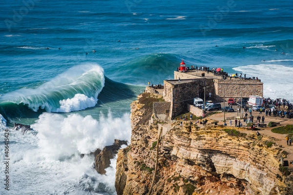Obraz Giant waves crashing near the Fort of Sao Miguel Arcanjo Lighthouse in Nazare, Portugal. 