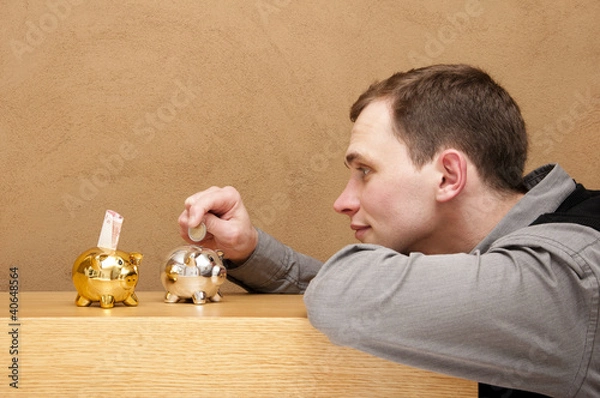 Obraz junger mann spart geld
