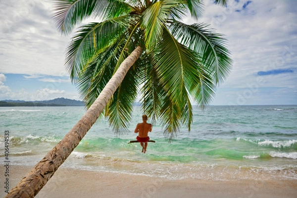 Obraz young man on a swing at a beach in Costa Rica