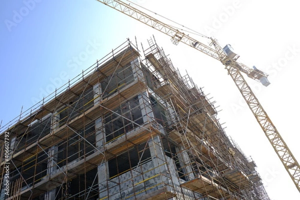 Obraz building under construction with tower crane
