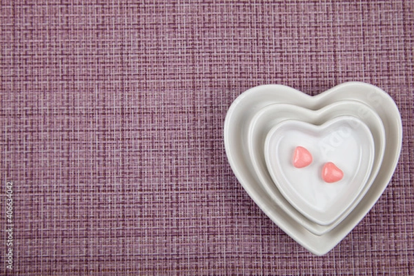 Fototapeta Plates with the shape of a heart and two sweets