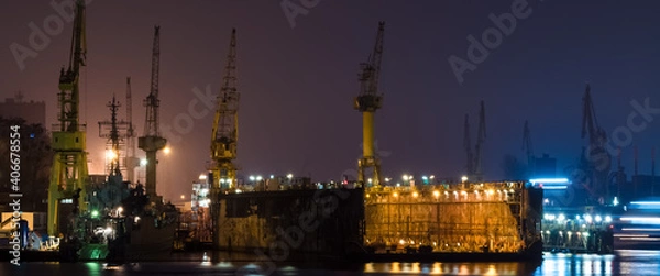 Fototapeta SHIPYARD - A floating repair dock and port cranes on the wharves

