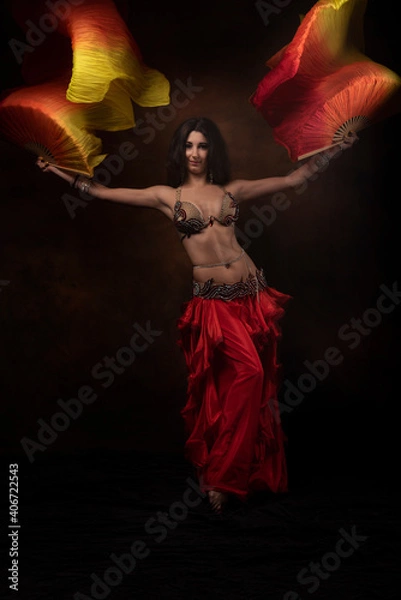 Obraz Oriental dancer with a saber. Belly dance. The brunette. Red.