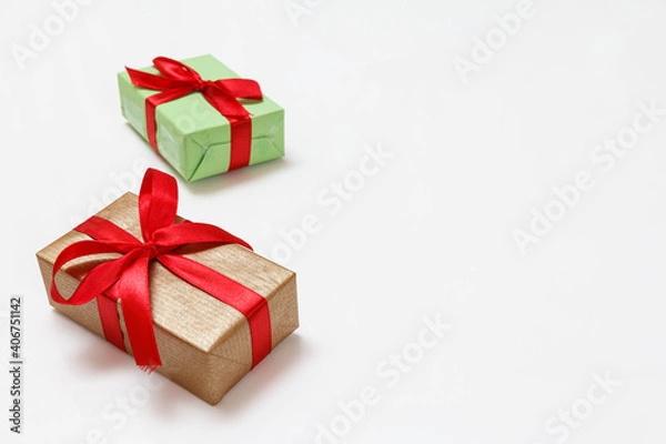 Fototapeta Gift boxes with red ribbons on white background.