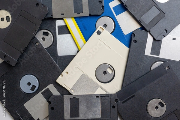 Fototapeta Scattered old floppy disks close-up, top view. 1980s and 1990s computer technology.