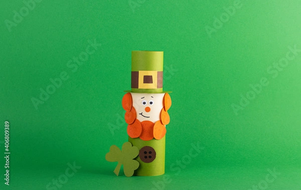 Obraz Green cute Leprechaun made of handmade paper on a green background, space for text