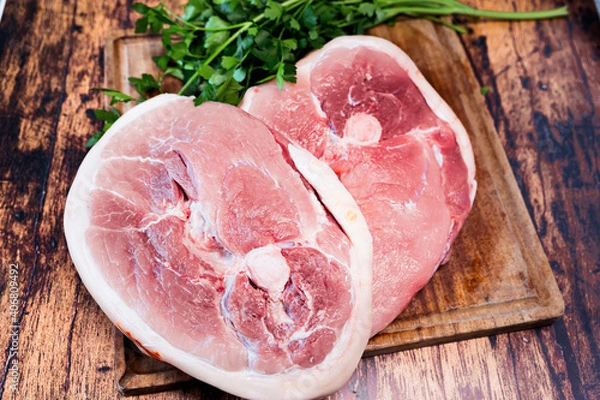 Fototapeta slice of fresh pork on a wooden cutting board