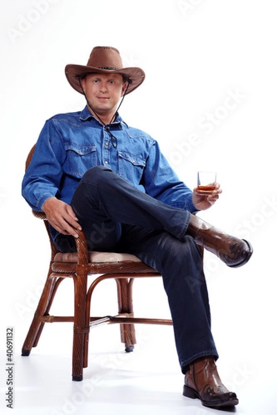 Fototapeta A cowboy with a glass of whiskey