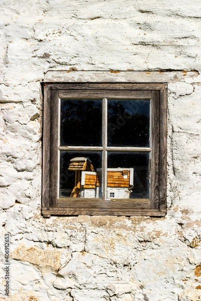 Fototapeta Small house in the window of an old cottage