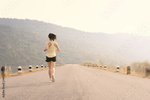Fototapeta Empty road with running girl in background