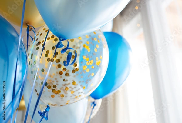 Obraz Blue and transparent balloons with golden confetti on the background of a large window. Light interior
