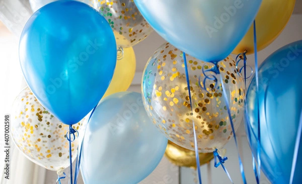 Obraz Blue and transparent balloons with golden confetti on the background of a large window. Light interior
