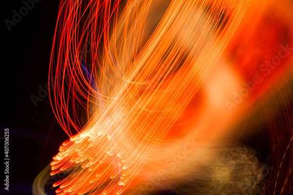Fototapeta Abstract light pattern. Blurred neon lights. A dynamic backdrop for your design. Bright orange