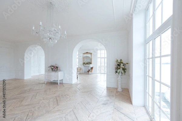 Fototapeta chic white huge spacious hall with a minimum of expensive antique furniture. Baroque interior design with ornament on the walls and parquet on the floor.