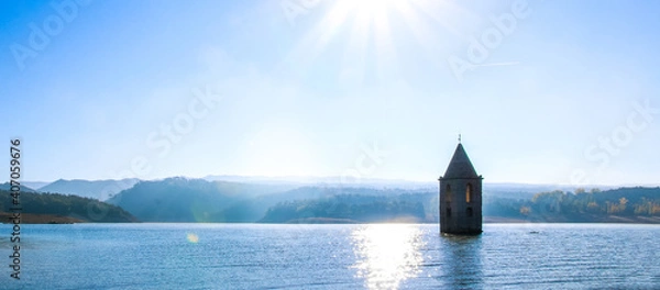 Fototapeta Historic church of the Sau swamp. Panoramic view of Sau Reservoir. Landscape of the Sau swamp in a sunny day. Tourism in Osona, Barcelona, Catalunya, Spain.