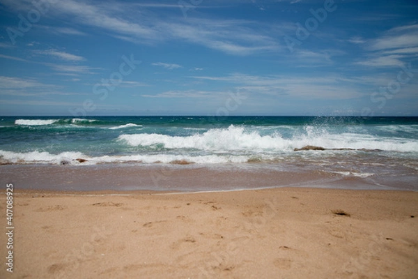 Obraz Beautiful sandy ocean beach with large rocks on the shore and in the water