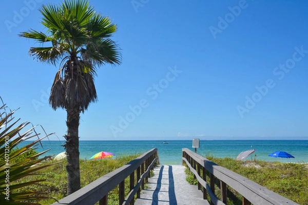 Obraz View of clear blue skies and calm ocean waters on a lovely warm sunny summer beach day from the boardwalk in St Petersburg / Clearwater Beach in Florida
