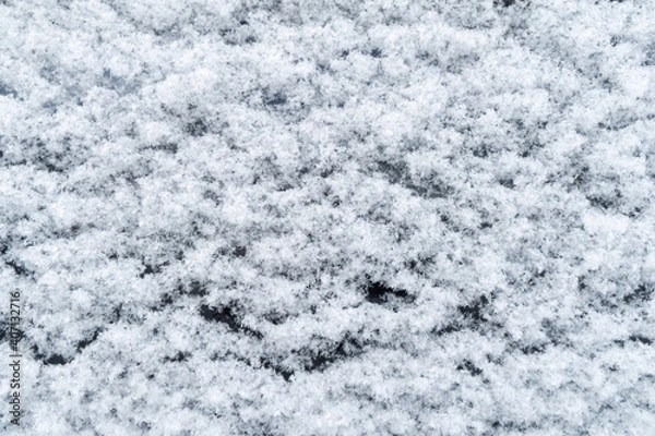 Fototapeta Background of fresh white snow. Winter snowflakes texture. Snow white texture winter background. Icy surface pattern. Shiny snow with bokeh